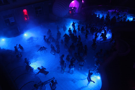 BUDAPEST, HUNGARY - NOVEMBER 2, 2013: Tourists enjoy the Magic Bath Party at the Lukacs Bath, a traditional night party in a historic outdoor thermal bath heated naturally by hot springs, in Budapest, Hungary, on November 2, 2013.のeditorial素材