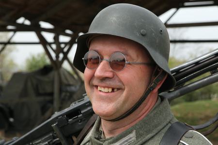 ORECHOV, CZECH REPUBLIC - APRIL 27, 2013: Re-enactor dressed as a German Nazi soldier prepares to...