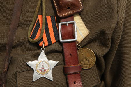 ORECHOV, CZECH REPUBLIC - APRIL 27, 2013: Soviet military decoration the Order of Glory (L) and the Medal for the Defence of Leningrad (R) seen during the re-enactment of the Battle at Orechov (1945) near Brno, Czech Republic. The Battle at Orechov in Aprのeditorial素材
