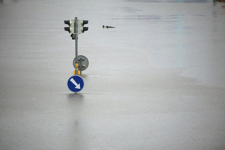 PRAGUE, CZECH REPUBLIC - JUNE 3, 2013: Flooded crossroad with traffic lights and a keep right traffic sign partially flooded by the swollen Vltava River in Prague, Czech Republic.のeditorial素材