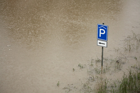 PRAGUE, CZECH REPUBLIC - JUNE 3, 2013: Covered parking, a traffic sign partially flooded by the swollen Vltava River in Prague, Czech Republic.のeditorial素材