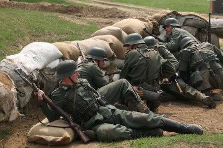 ORECHOV, CZECH REPUBLIC - APRIL 27, 2013: Re-enactors dressed as German Nazi soldiers stage an attack during the re-enactment of the Battle at Orechov (1945) near Brno, Czech Republic. The Battle at Orechov in April 1945 was the biggest tank battle in theのeditorial素材