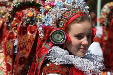 VLCNOV, CZECH REPUBLIC - MAY 26, 2013: Young women dressed in traditional Moravian folk costumes attend the Ride of the Kings folklore festival in Vlcnov, South Moravia, Czech Republic.のeditorial素材