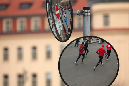 PRAGUE, CZECH REPUBLIC - APRIL 6, 2013: Convex mirrors with the reflection of athletes running the Prague international marathon in Prague, Czech Republic.のeditorial素材