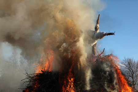 BURG, GERMANY - APRIL 7, 2012: Straw doll symbolizing winter is burned at the traditional Easter bonfire in the Lusatian village of Burg in Spreewald Region, Lower Lusatia, Brandenburg, Germany.のeditorial素材