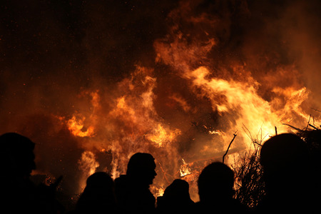 BURG, GERMANY - APRIL 7, 2012: People look at the traditional Easter bonfire in the Lusatian village of Burg in Spreewald Region, Lower Lusatia, Brandenburg, Germany.のeditorial素材