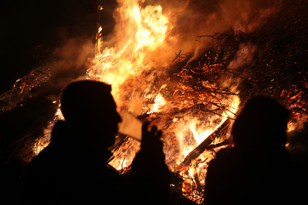BURG, GERMANY - APRIL 7, 2012: People look at the traditional Easter bonfire in the Lusatian village of Burg in Spreewald Region, Lower Lusatia, Brandenburg, Germany.のeditorial素材