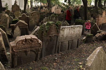 PRAGUE, CZECH REPUBLIC - OCTOBER 15, 2012: People walk among abandoned tombstones at the Old Jewish Cemetery in Prague, Czech Republic.のeditorial素材