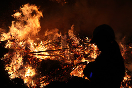 BURG, GERMANY - APRIL 7, 2012: People look at the traditional Easter bonfire in the Lusatian village of Burg in Spreewald Region, Lower Lusatia, Brandenburg, Germany.のeditorial素材