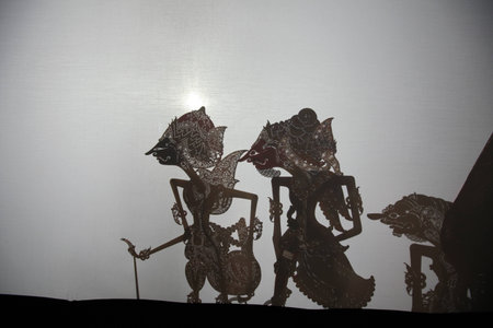 YOGYAKARTA, INDONESIA - AUGUST 13, 2012: Traditional Indonesian shadow puppet theatre wayang kulit performs in the Sasono Hinggil Theatre in Yogyakarta, Central Java, Indonesia.のeditorial素材