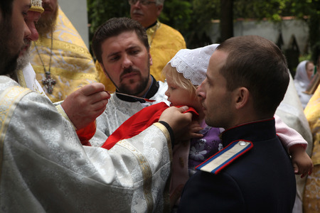 PRAGUE, CZECH REPUBLIC - MAY 28, 2012: Young girl receives the Eucharist during an orthodox service...