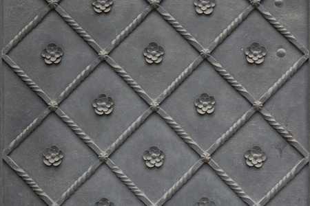 Old metal gate covered with floral pattern. Background texture.の写真素材
