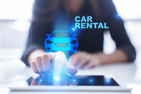 Womans hands pressing on tablet pc screen and select Car Rental.の写真素材