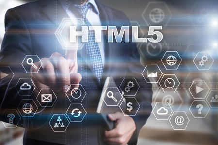 Businessman is pressing on the virtual screen and selecting "HTML5".の写真素材