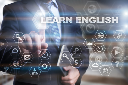 Businessman is pressing on the virtual screen and selecting "Learn English".の写真素材