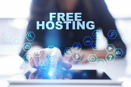 Woman is using tablet pc, pressing on virtual screen and selecting free hostingの写真素材