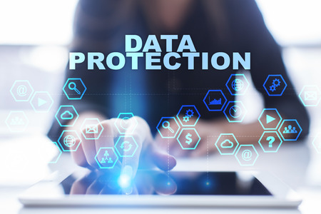 Woman is using tablet pc, pressing on virtual screen and selecting data protectionの写真素材