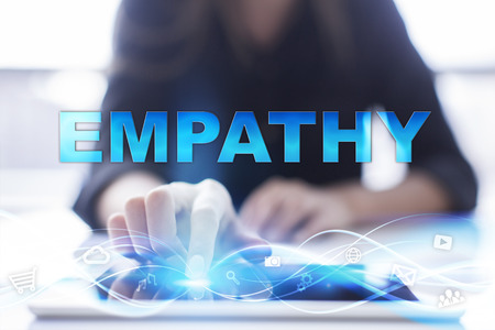 Woman is using modern tablet pc, presssing on touch screen and selecting "Empathy".の写真素材