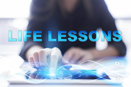 Woman is using modern tablet pc, presssing on touch screen and selecting "Life lessons".の写真素材