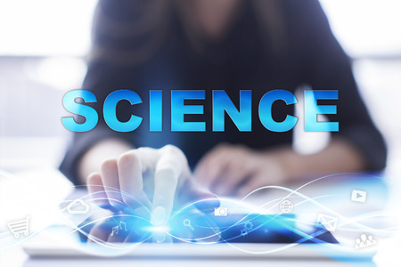 Woman is using modern tablet pc, presssing on touch screen and selecting "Science".の写真素材