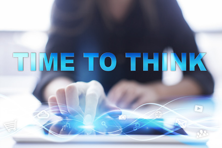 Woman is using modern tablet pc, presssing on touch screen and selecting "Time to think".の写真素材