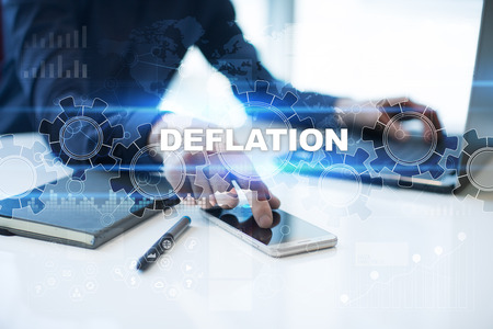 Businessman is working in office, pressing button on virtual screen and selecting deflation.の写真素材
