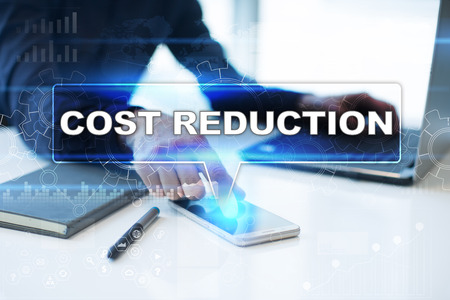 Businessman working in office, pressing button on virtual screen and selecting cost reduction.の写真素材