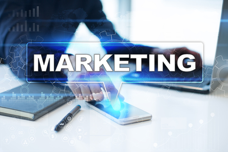 Businessman working in office, pressing button on virtual screen and selecting marketing.の写真素材