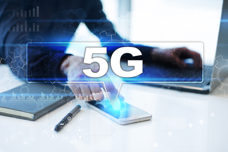 Businessman working in office, pressing button on virtual screen and selecting 5g.の写真素材