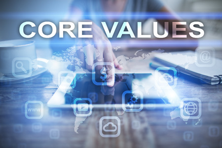 Woman using tablet pc, pressing on virtual screen and selecting core values.の写真素材