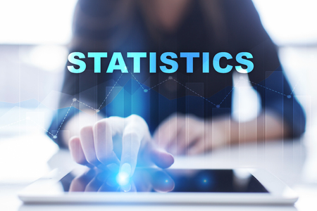Woman using tablet pc and selecting statistics.の写真素材