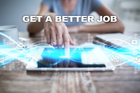Woman using tablet pc, pressing on virtual screen and selecting get a better job.の写真素材