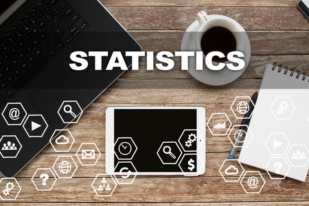 Tablet on desktop with statistics text.の写真素材