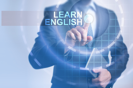 Businessman selecting learn english on virtual screen.の写真素材