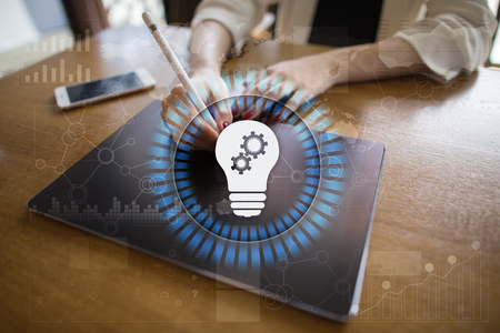 Lamp icon on virtual screen. Business solution. Innovation concept.の写真素材