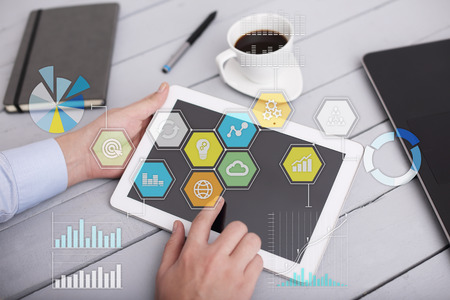 Colored applications icons and graphs on virtual screen. Business, internet and technology concept.の写真素材