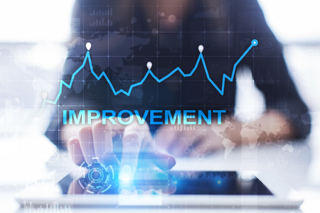 Improvement graph on virtual screen. Business and technology concept. の写真素材