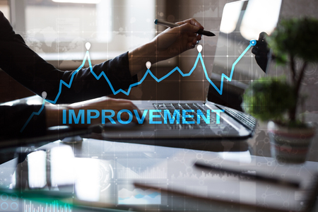 Improvement graph on virtual screen. Business and technology concept. の写真素材