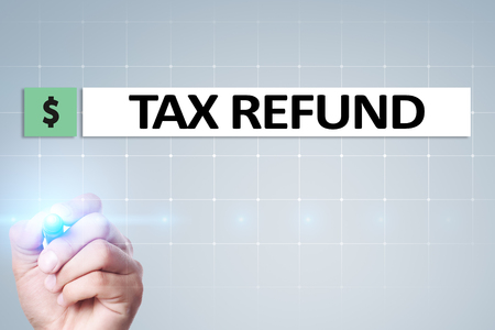 Tax refund text on virtual screen. Business and Finance concept.の写真素材