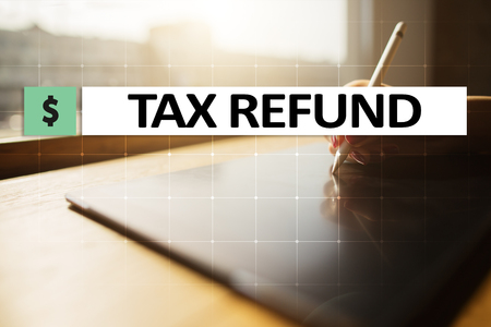 Tax refund text on virtual screen. Business and Finance concept.の写真素材