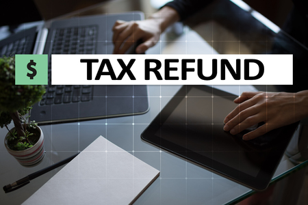 Tax refund text on virtual screen. Business and Finance concept.の写真素材