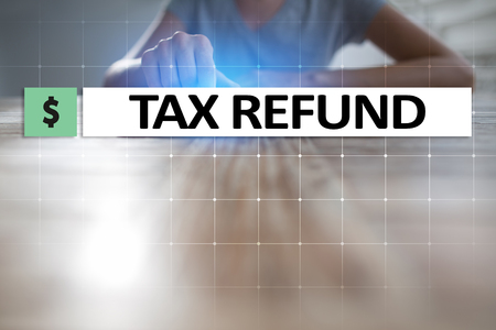 Tax refund text on virtual screen. Business and Finance concept.の写真素材