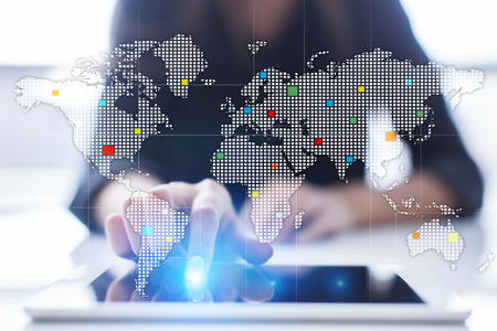Worlds maps on virtual screen. Business, internet and technology concept.の写真素材