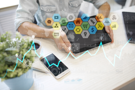Colored applications icons and graphs on virtual screen. Business, internet and technology concept.の写真素材