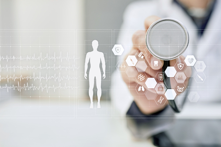 Doctor using modern computer with Medical record diagram on virtual screen concept. Health monitoring application.の写真素材