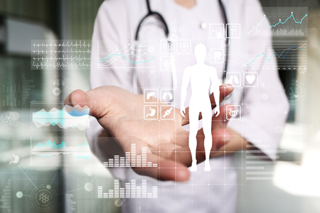 Doctor using modern computer with Medical record diagram on virtual screen concept. Health monitoring application.の写真素材