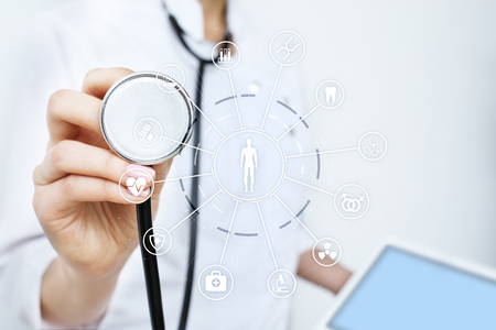 Medicine doctor with modern computer, virtual screen interface and icon medical network connection. Medical technology network and health care concept.の写真素材