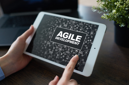 Agile software development principle. Pressing button on virtual screen. Internet and technology concept.の写真素材