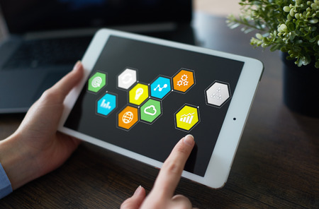 Colored applications icons and graphs on virtual screen. Business, internet and technology concept.の写真素材