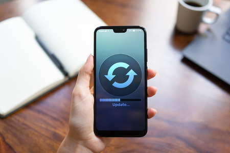 Software Update downloading progress on smartphone screen. Internet and technology concept.の写真素材